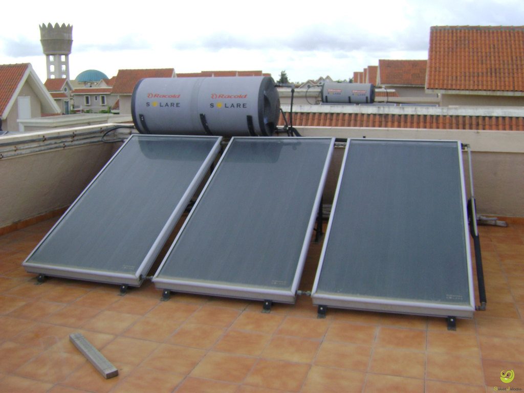 Solar water heating panels and a tank on a sunny flat roof